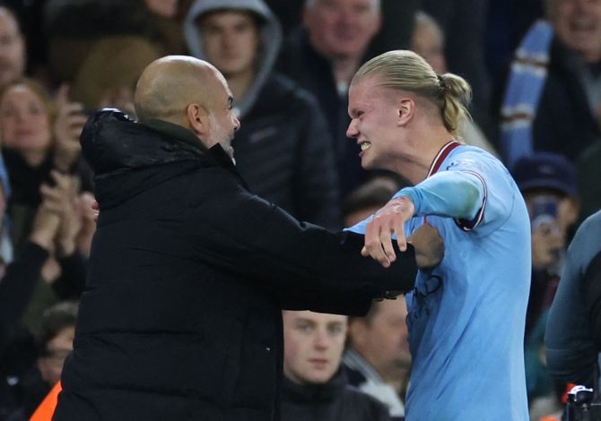 Manchester City manager Pep Guardiola and Erling Haaland celebrate after the match.