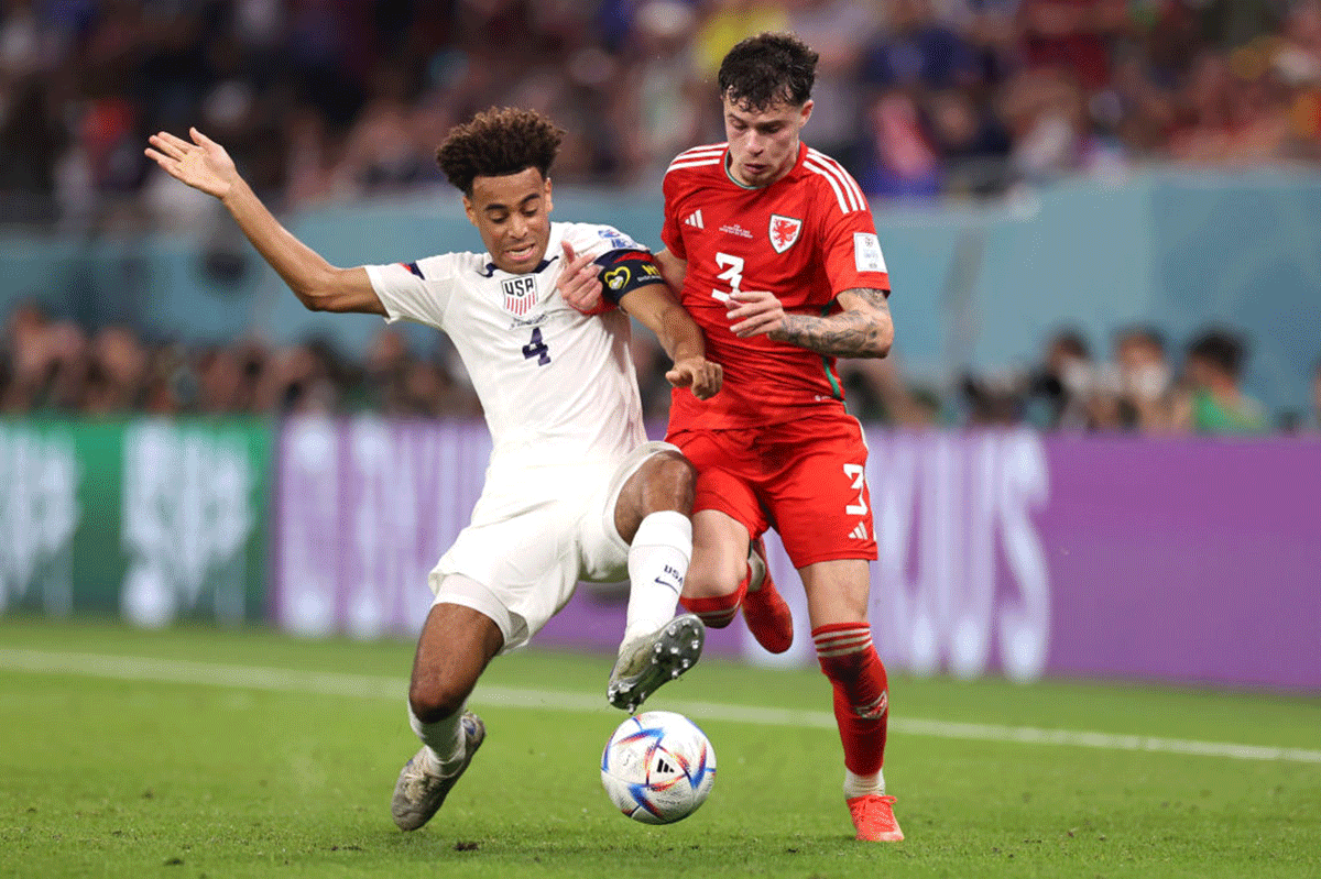 Wales' Neco Williams and USA's Tyler Adams battle for the ball