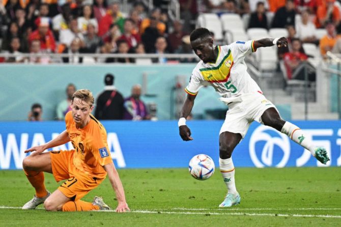 Idrissa Gana Gueye of Senegal shoots from Netherlands' Frenkie de Jong during the FIFA World Cup Qatar 2022