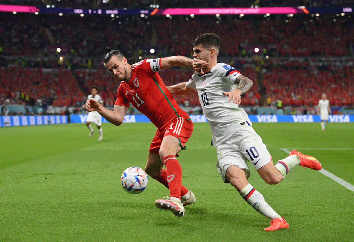 Wales' Gareth Bale celebrates after scoring their team's first goal via a penalty past USA 'keeper Matt Turner during their FIFA World Cup Qatar 2022 Group B match at Ahmad Bin Ali Stadium in Doha, Qatar, on Monday