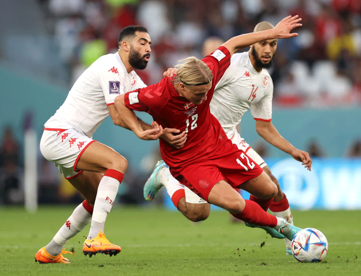 Denmark's Kasper Dolberg is fouled by Tunisia's Yassine Meriah during their FIFA World Cup Group D match at Education City Stadium in Al Rayyan, Qatar on Tuesday