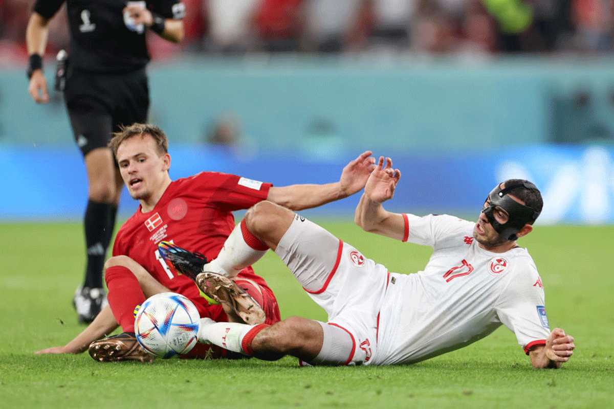 Tunisia's Ellyes Skhiri battles for possession with Denmark's Mikkel Damsgaard 
