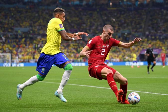 Strahinja Pavlovic of Serbia controls the ball under pressure of Raphinha of Brazil 