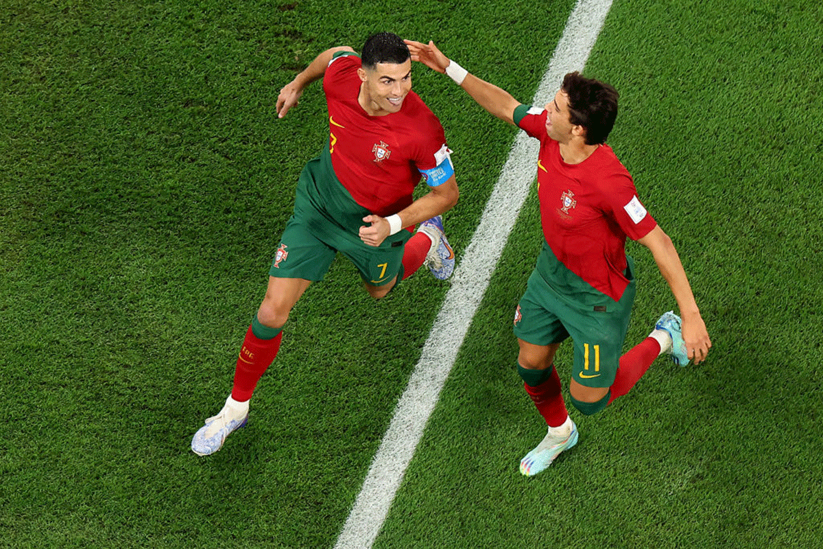 Portugal's Cristiano Ronaldo celebrates with Joao Felix after scoring their team's first goal via a penalty during the FIFA World Cup Group H match against Ghana at Stadium 974 in Doha, Qatar on Thursday