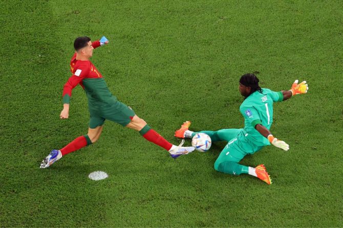 Lawrence Ati Zigi of Ghana saves an attempt by Cristiano Ronaldo of Portugal