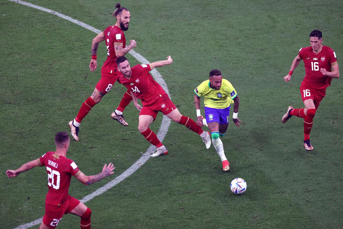 Neymar dribbles his way between Serbia's Andrija Zivkovic (left) and Sasa Lukic (right) during the match.