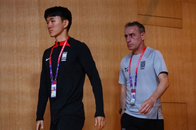 South Korea's Hwang In-beom and coach Paulo Bento during the press conference.
