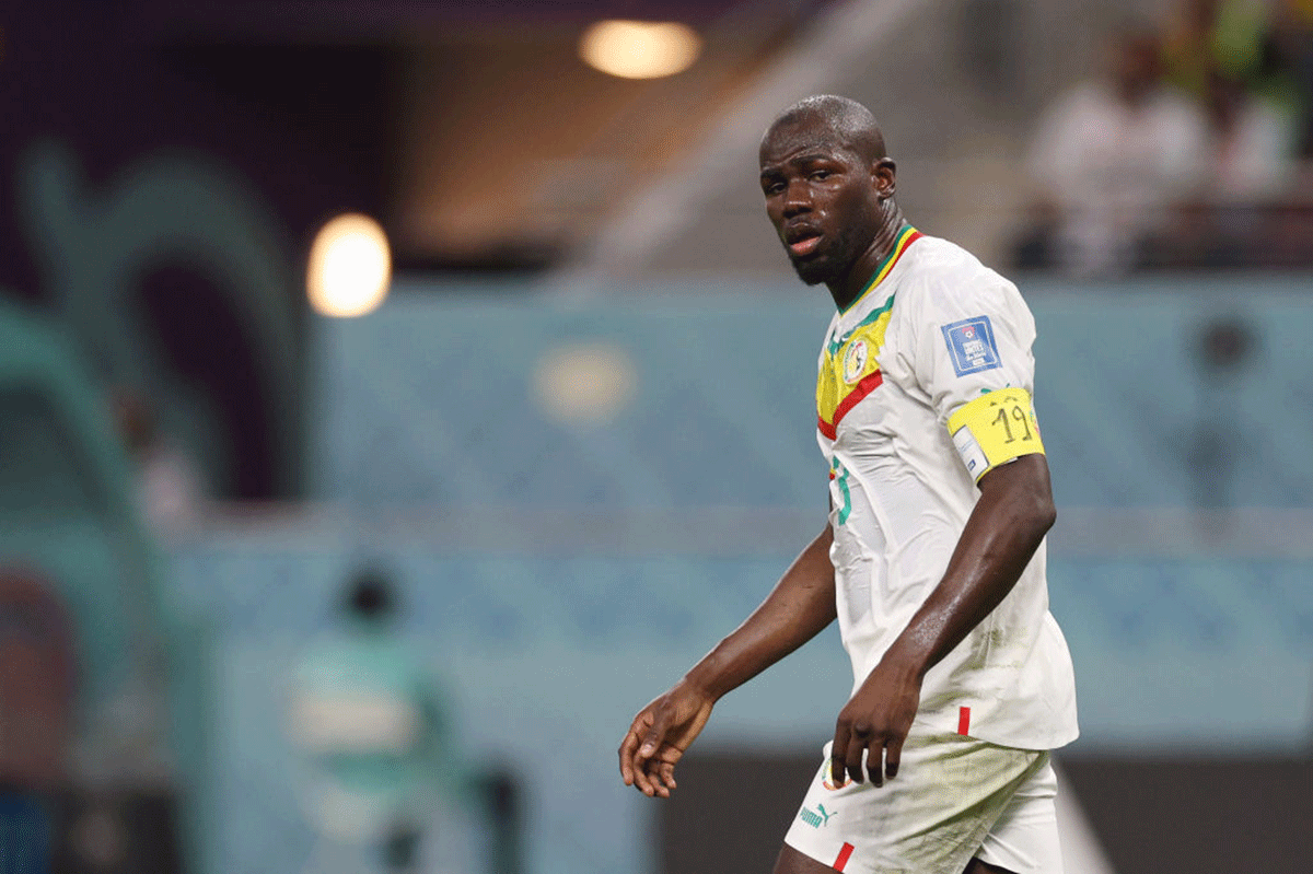 Senegal captain Kalidou Koulibaly dons an armband that has "19" on it -- Diop's shirt number with Senegal.