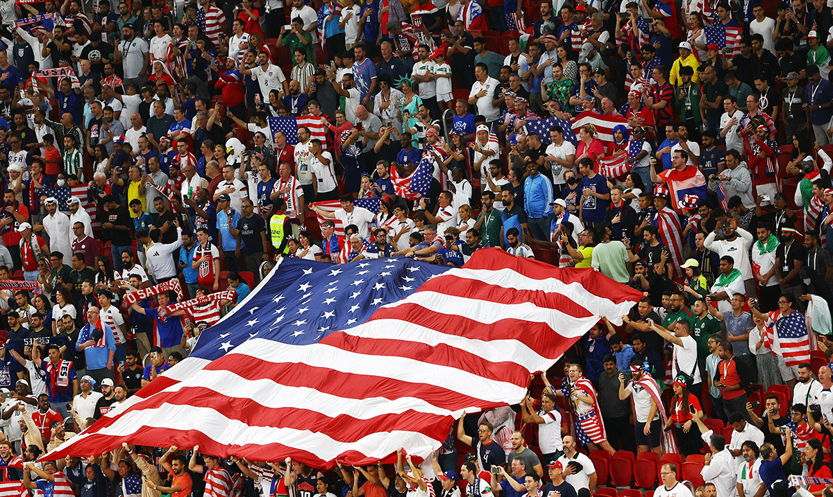  Fans display a United States flag in the stands before the match ahead of the match between USA and Iran