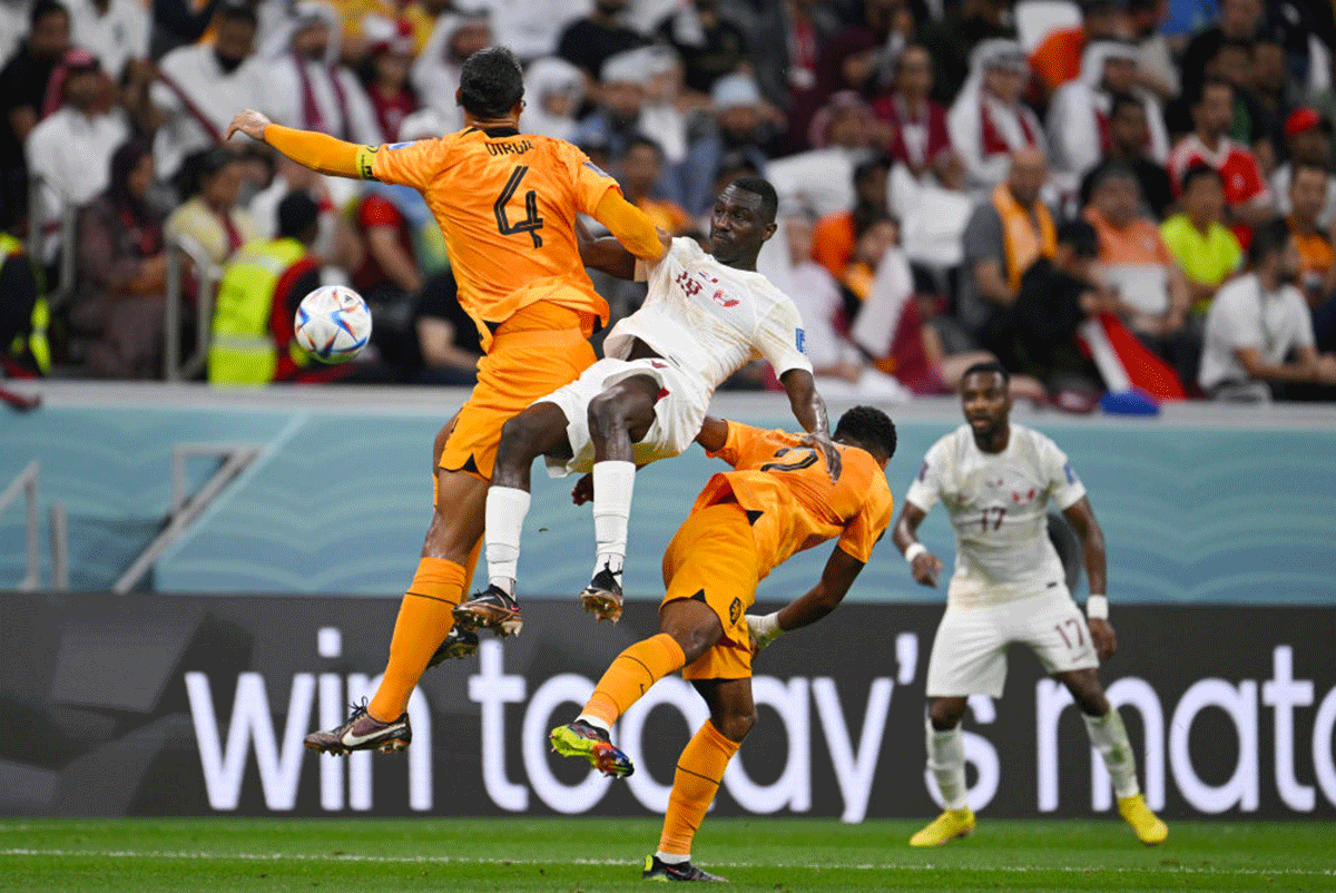 The Netherlands' Virgil Van Dijk and Qatar's Almoez Ali