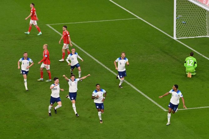 Marcus Rashford celebrates after scoring England's third goal.