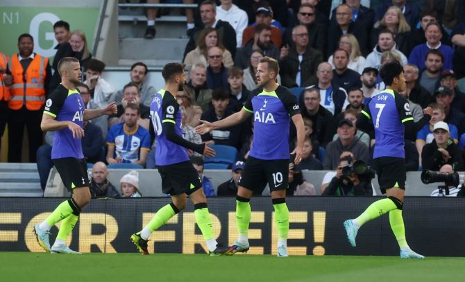 Harry Kane celebrates with Rodrigo Bentancur after scoring Tottenham Hotspur's goal against Brighton & Hove Albion at the American Express Community Stadium, Brighton.