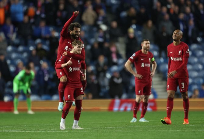 Harvey Elliott celebrates scoring Liverpool's seventh goal with Mohamed Salah.