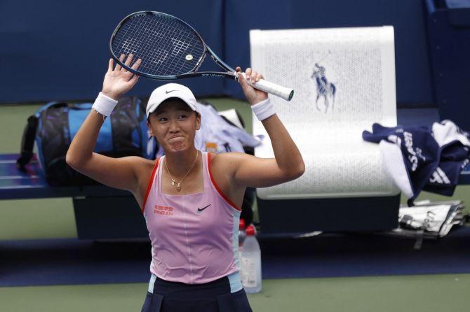 China's Wang Xiyu waves to the crowd after defeating Greece's Maria Sakkari.
