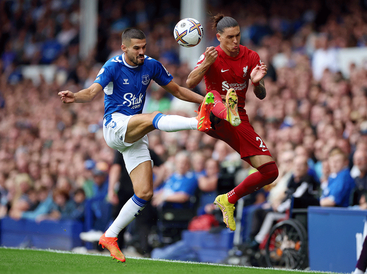 Liverpool's Darwin Nunez and Everton's Conor Coady battle for possession