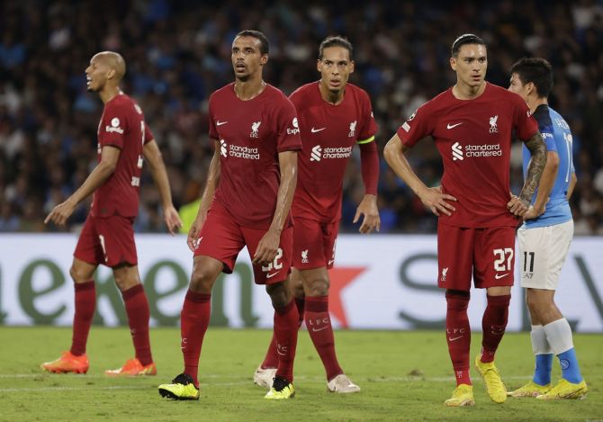 Liverpool's Joel Matip, Darwin Nunez and Virgil van Dijk leave the field in disbelief after the humiliating defeat.