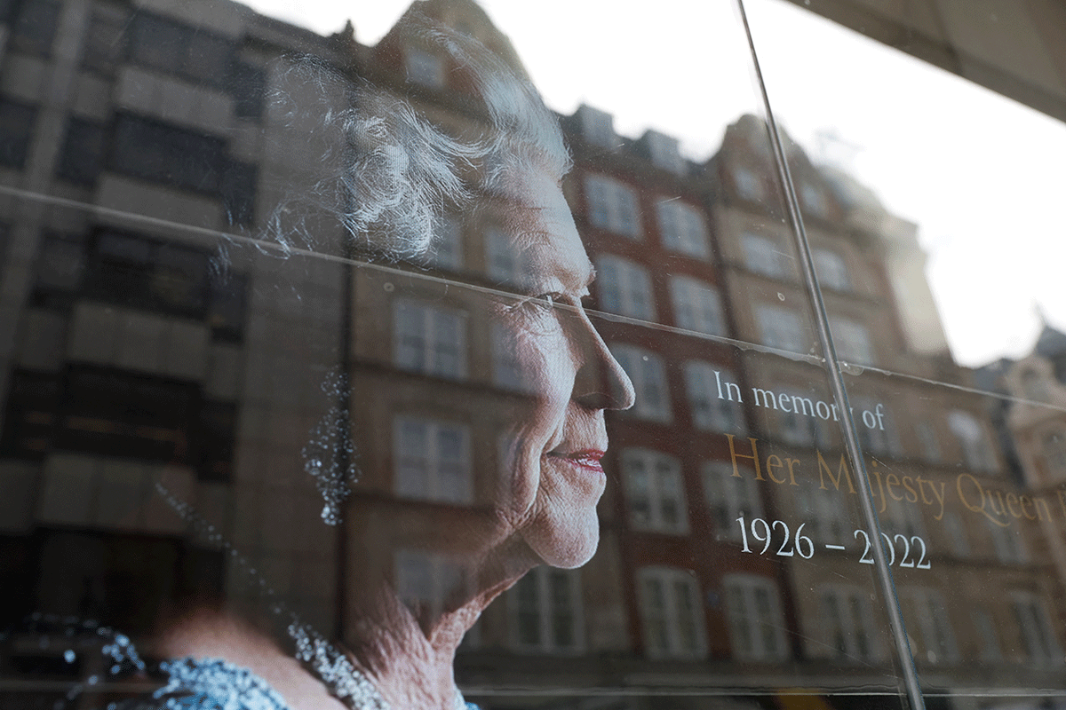 A sign with a picture of the queen is displayed in an office window, in London, Britain