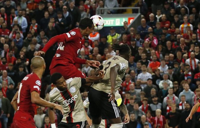 Joel Matip rises above a host of defenders to head home Liverpool's second goal in the Champions League Group A match against Ajax Amsterdam, at Anfield, Liverpool, on Tuesday.
