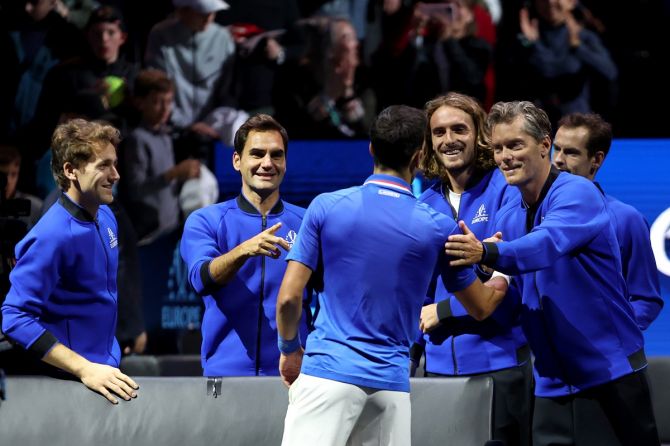 Novak Djokovic is congratulated by Casper Ruud, Roger Federer, Stefanos Tsitsipas and Thomas Enqvist, vice-captain of Team Europe, after the match against Frances Tiafoe.
