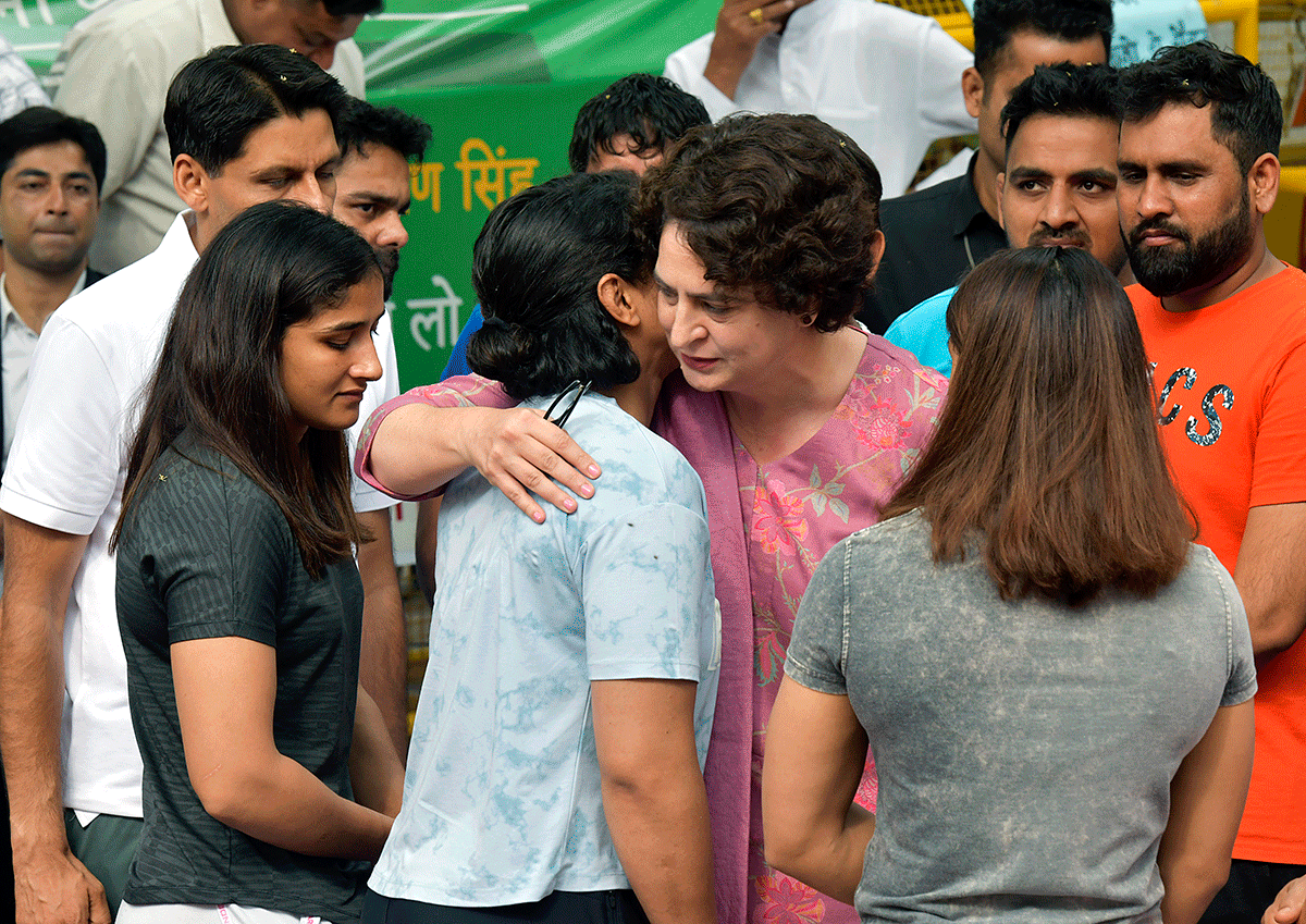 Congress General Secretary Priyanka Gandhi Vadra consoles wrestler Sakshi Malik, Vinesh Phogat and others before departing from the protest site at Jantar Mantar in New Delhi on Saturday. 