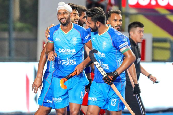 India captain Harmanpreet Singh celebrates with Mandeep Singh after scoring against China on Thursday. It was Mandeep's 100th goal in an India shirt. 