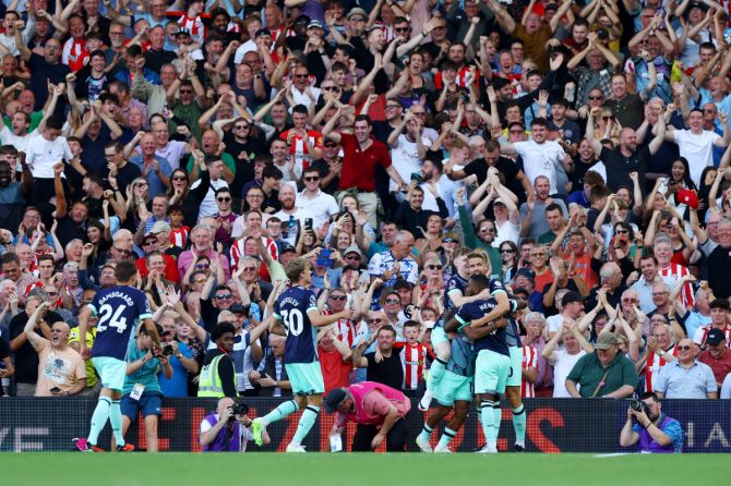 Brentford's Bryan Mbeumo their third goal  has fans and teammates in a delirium during their match against Fulham at Craven Cottage