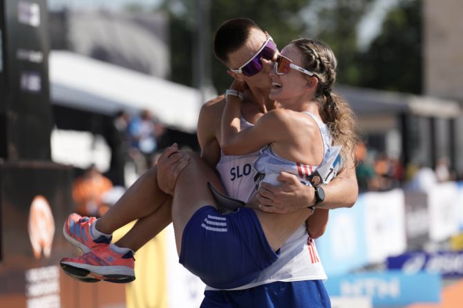 Slovakia's Dominik Cerny carries girlfriend Hana Burzalova after a marriage proposal at the finish line