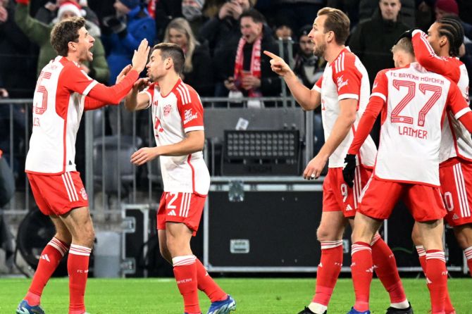 Bayern Munich's Harry Kane celebrates scoring their first goal with Thomas Mueller 