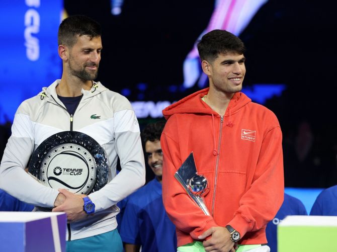Carlos Alcaraz and Novak Djokovic pose with their trophies after the Riyadh Season Tennis Cup exhibition match at Kingdom Arena in Saudi Arabia on Wednesday.