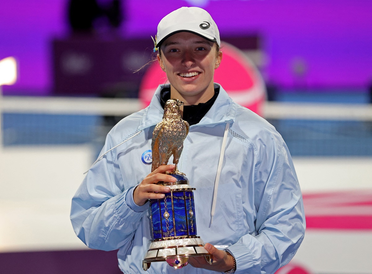 Poland's Iga Swiatek celebrates with the trophy after defeating  Jessica Pegula of the United States in the final of the Qatar Open, at Khalifa International Tennis and Squash Complex, Doha, on Saturday.