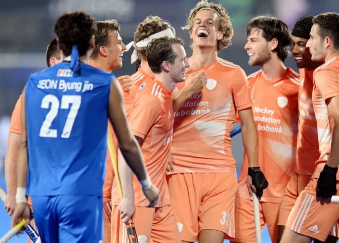 The Netherlands players celebrate a goal against the Koreans.