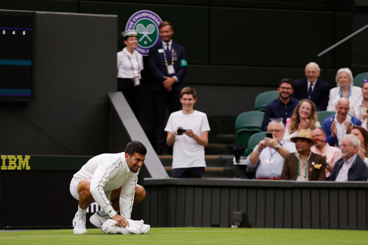 Novak Djokovic wipes centre court with a towel 