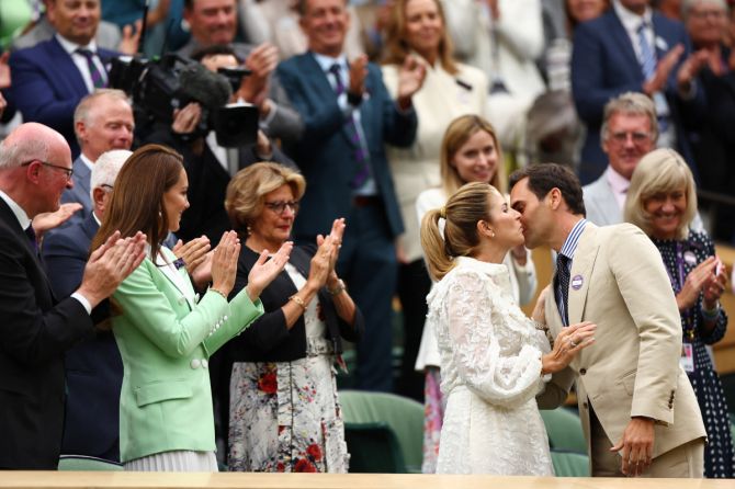Roger Federer kisses wife Mirka during the presentation on Centre Court
