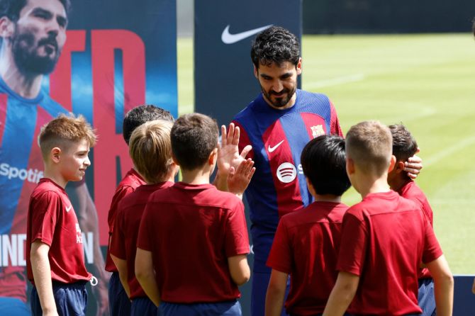 New FC Barcelona player Ilkay Gundogan greets children during his unveiling at Ciutat Esportiva Joan Gamper, Barcelona, on Monday