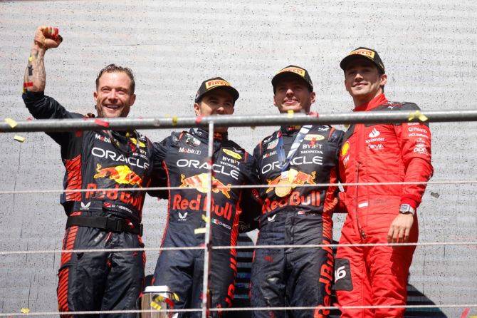 Red Bull's Max Verstappen celebrates on the podium after winning the race alongside second placed Red Bull's Sergio Perez and third placed Ferrari's Charles Leclerc