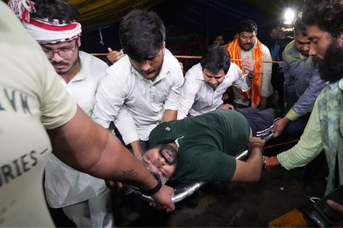 An injured wrestler is stretchered out after a scuffle between the police and the protesting wrestlers at Jantar Mantar on Wednesday