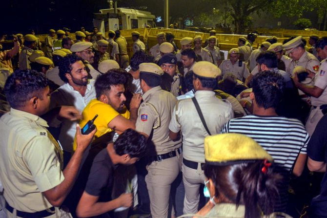 Police personnel and protesting wrestlers in a scuffle at Jantar Mantar, in New Delhi, Wednesday, 