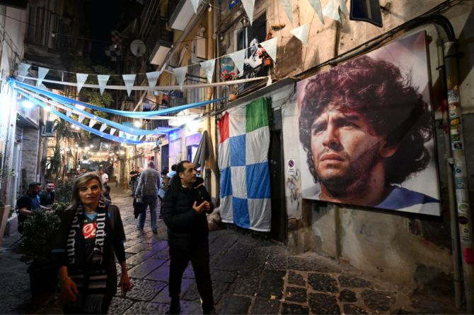 A mural of Diego Maradona is seen in the city centre as fans of SSC Napoli celebrate in Naples, Italy. 