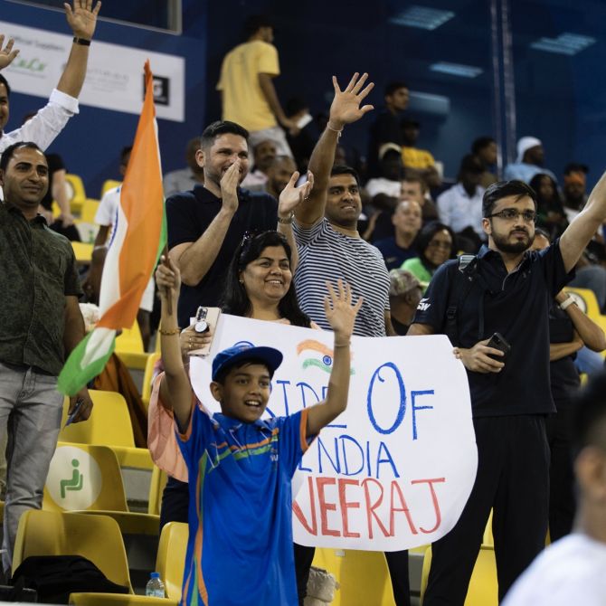 Indian fans at the Suheim bin Hamad Stadium in Doha celebrate Neeraj Chopra's success.