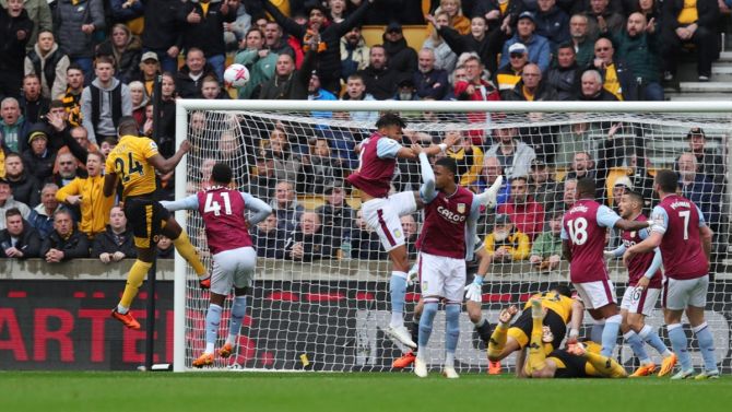 Toti Gomes (No. 24) scores for Wolverhampton Wanderers with a header against Aston Villa, at Molineux Stadium, Wolverhampton.
