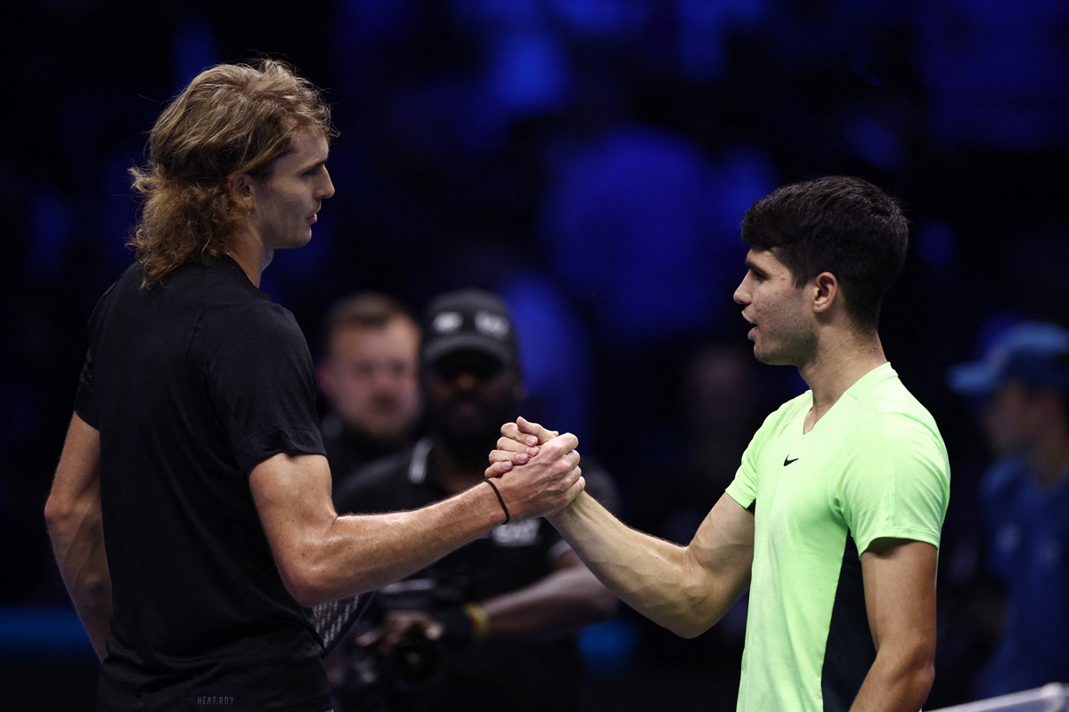 Germany's Alexander Zverev shakes hands with Spain's Carlos Alcaraz after winning the group stage match at the ATP Finals in Turin, Italy, on Monday.