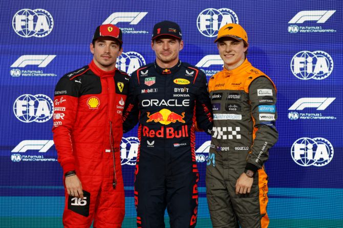Red Bull's Max Verstappen celebrates after qualifying in pole position with Ferrari's Charles Leclerc and McLaren's Oscar Piastri during the Abu Dhabi Grand Prix at Yas Marina Circuit in Abu Dhabi on Saturday 