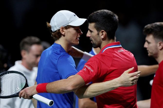 Serbia's Novak Djokovic and Italy's Jannik Sinner embrace after their Davis Cup Finals semi-final doubles match, at Palacio de deportes Martin Carpena, Malaga, Spain, on Saturday.