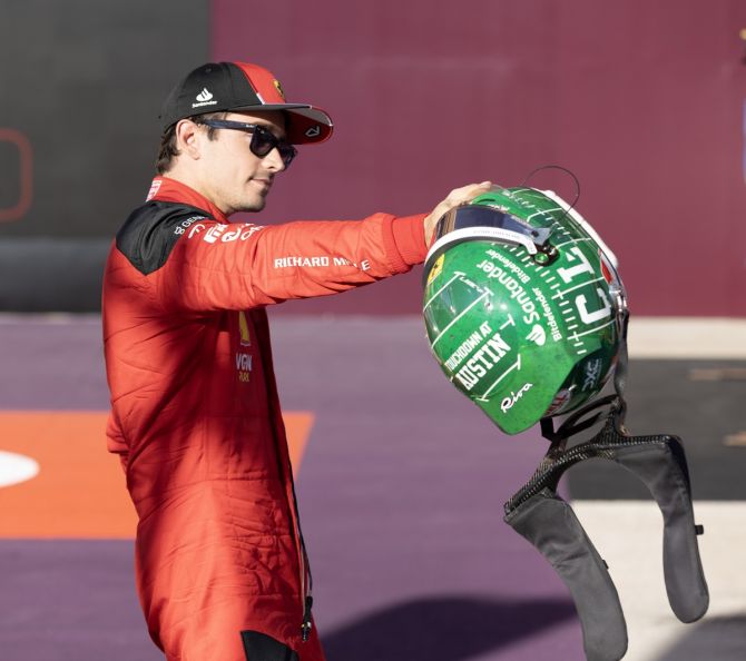 Ferrari's Charles Leclerc hands his team his helmet after finishing on top in qualifying at the Formula 1 United States Grand Prix, at Circuit of the Americas, on Friday.