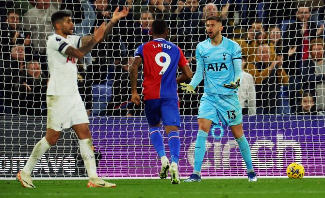 Jordan Ayew celebrates scoring for Crystal Palace in added time as Tottenham Hotspur's Guglielmo Vicario and Cristian Romero remonstrate.