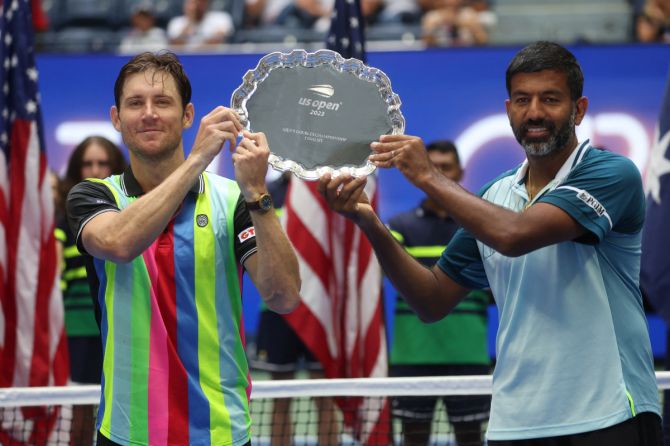 Australia's Matthew Ebden and India's Rohan Bopanna pose with the runners up trophy after losing the men's double final against Britain's Joe Salisbury and Rajeev Ram of the US at  Flushing Meadows, New York, on Friday