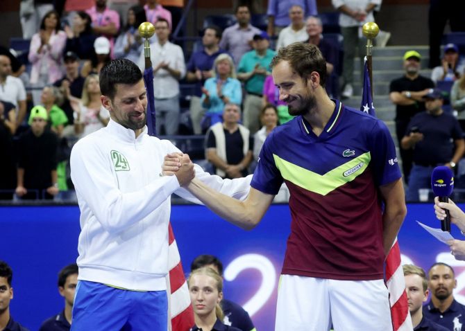 Novak Djokovic and Daniil Medvedev share a light moment before the trophies presentation.