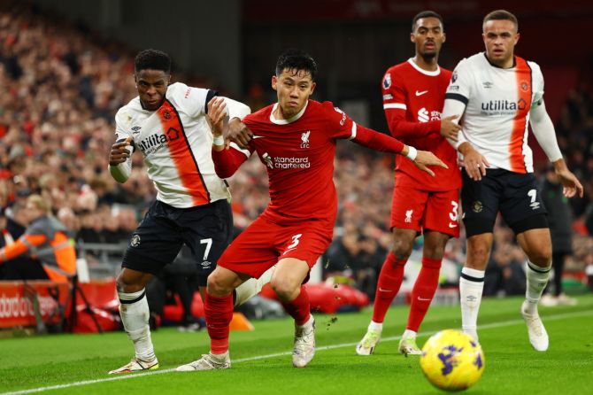 Luton Town's Chiedozie Ogbene vies with Liverpool's Wataru Endo