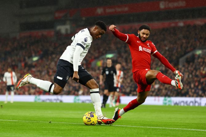 Luton Town's Chiedozie Ogbene in action with Liverpool's Joe Gomez