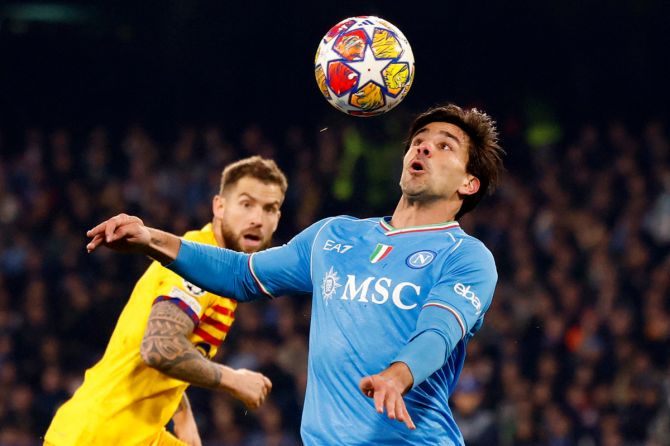 Napoli's Giovanni Simeone in action with FC Barcelona's Inigo Martinez
